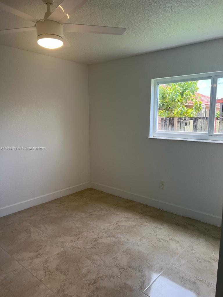 2670 West 76th Street, Unit 101 Hialeah, FL 33016 - Photo 22 of 35 an empty room with a window