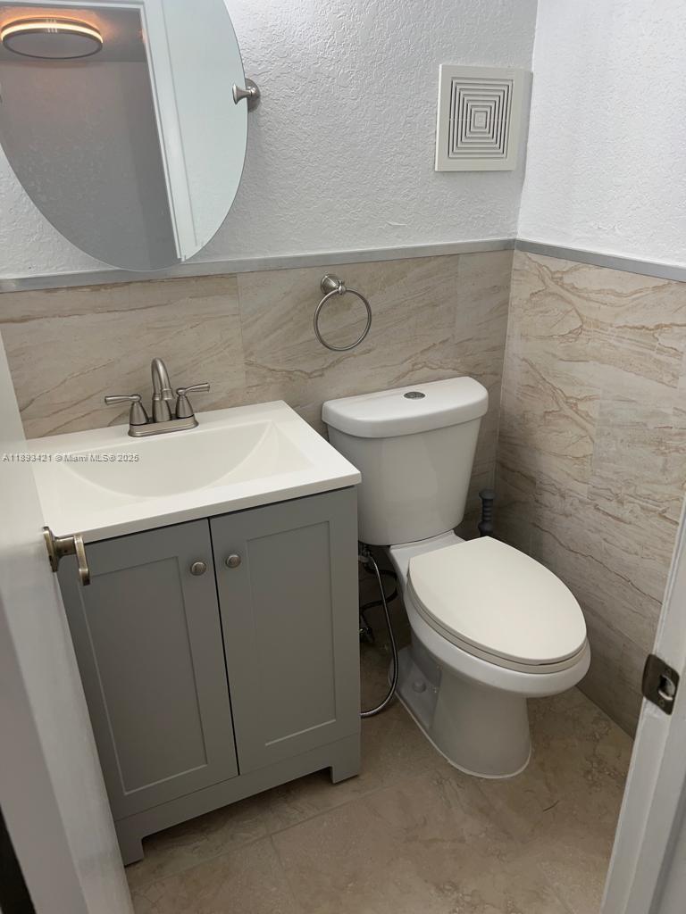2670 West 76th Street, Unit 101 Hialeah, FL 33016 - Photo 26 of 35 a bathroom with a toilet sink and mirror