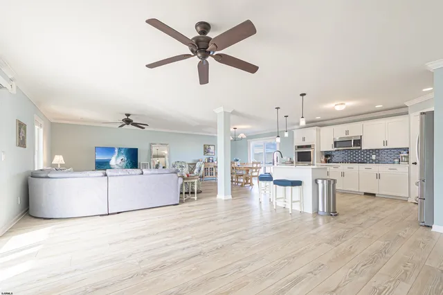 a living room with furniture and kitchen view