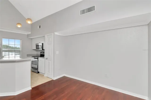 an empty room with a bathroom and a ceiling fan