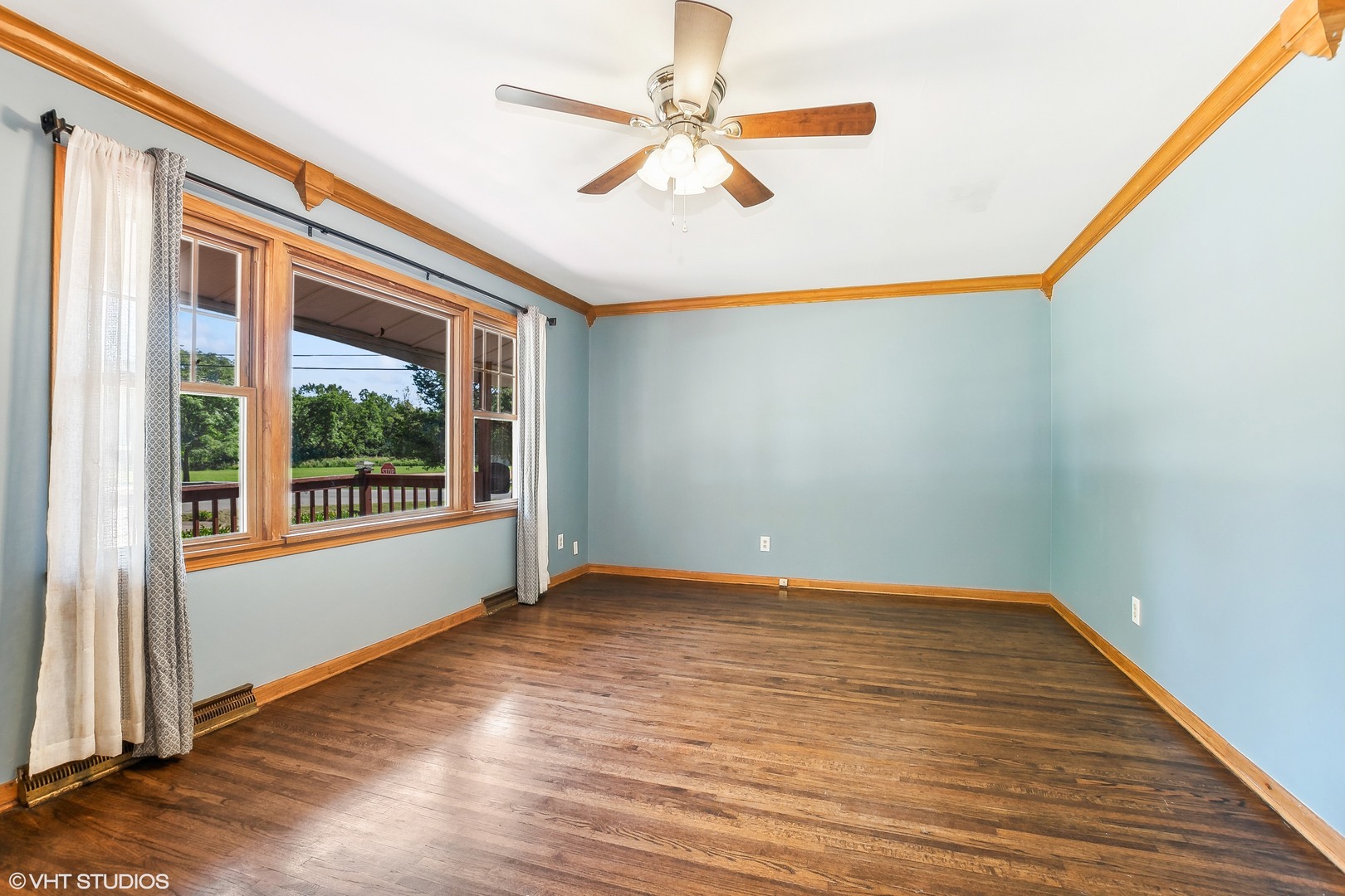 304 Hillside Road New Lenox, IL 60451 - Photo 3 of 16 a view of an empty room with a window and wooden floor