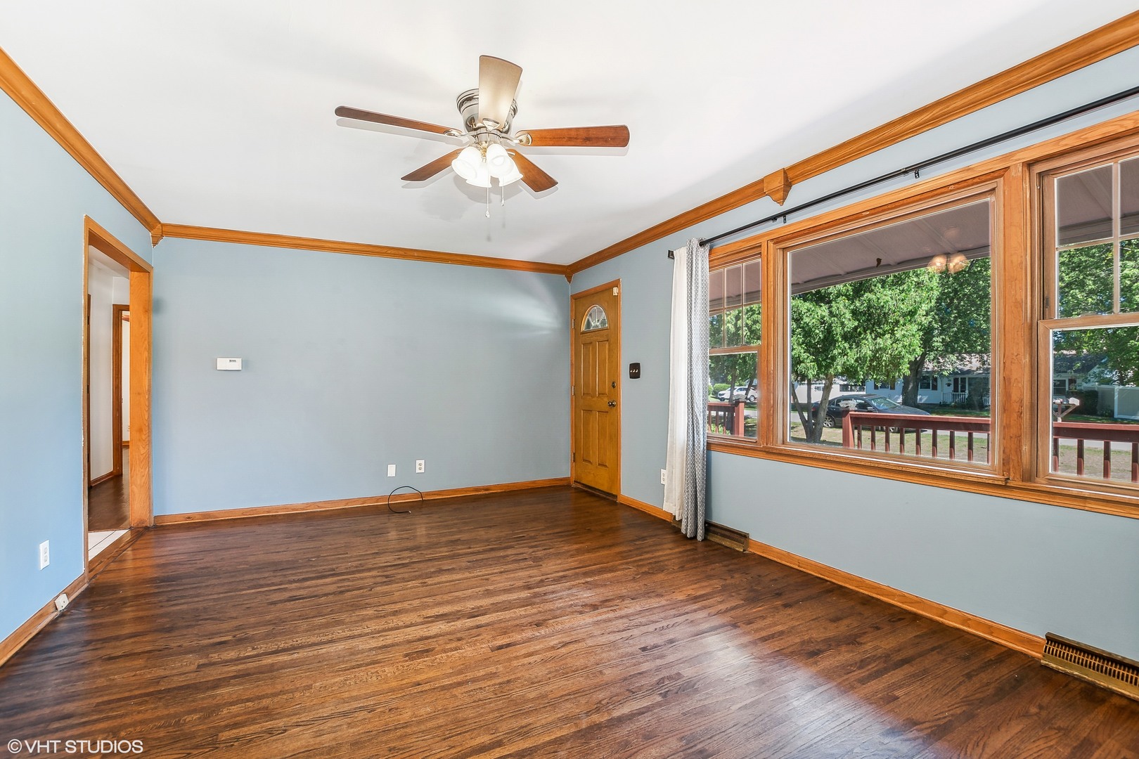 304 Hillside Road New Lenox, IL 60451 - Photo 4 of 16 a view of an empty room with wooden floor and a window