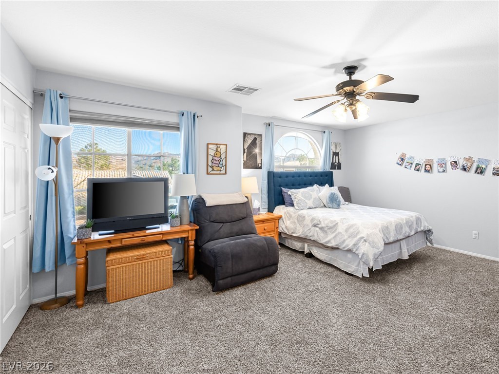 2199 Maple Shade Street Henderson, NV 89002 - Photo 25 of 75 Oversized Bedroom 2 featuring carpet flooring and a ceiling fan.