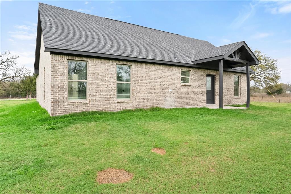 6771 Northwest County Road 1146 Barry, TX 75102 - Photo 33 of 34 a front view of house with backyard and green space