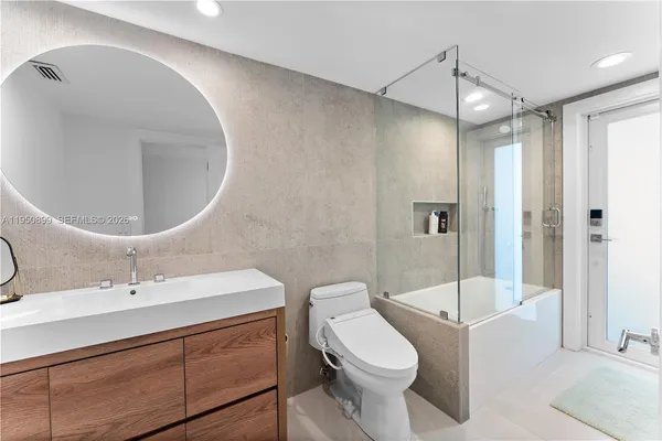 a bathroom with a sink toilet and shower