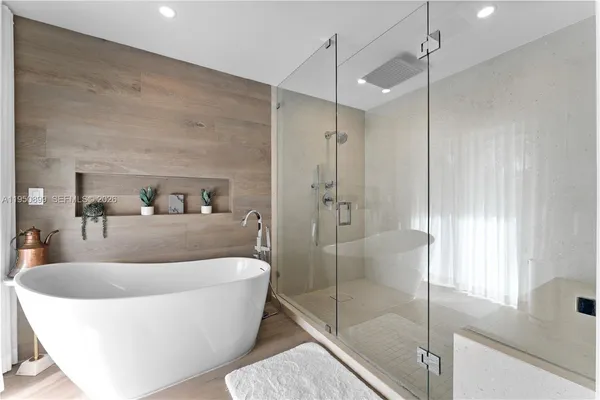 a white bath tub sitting in a bathroom