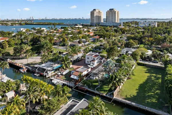 an aerial view of a city with lots of residential buildings lake and ocean view