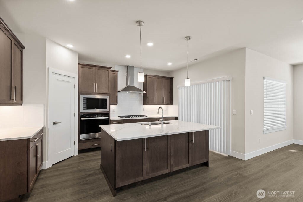 3819 194th Place Southeast Bothell, WA 98012 - Photo 9 of 33 a kitchen with kitchen island a sink stainless steel appliances and cabinets
