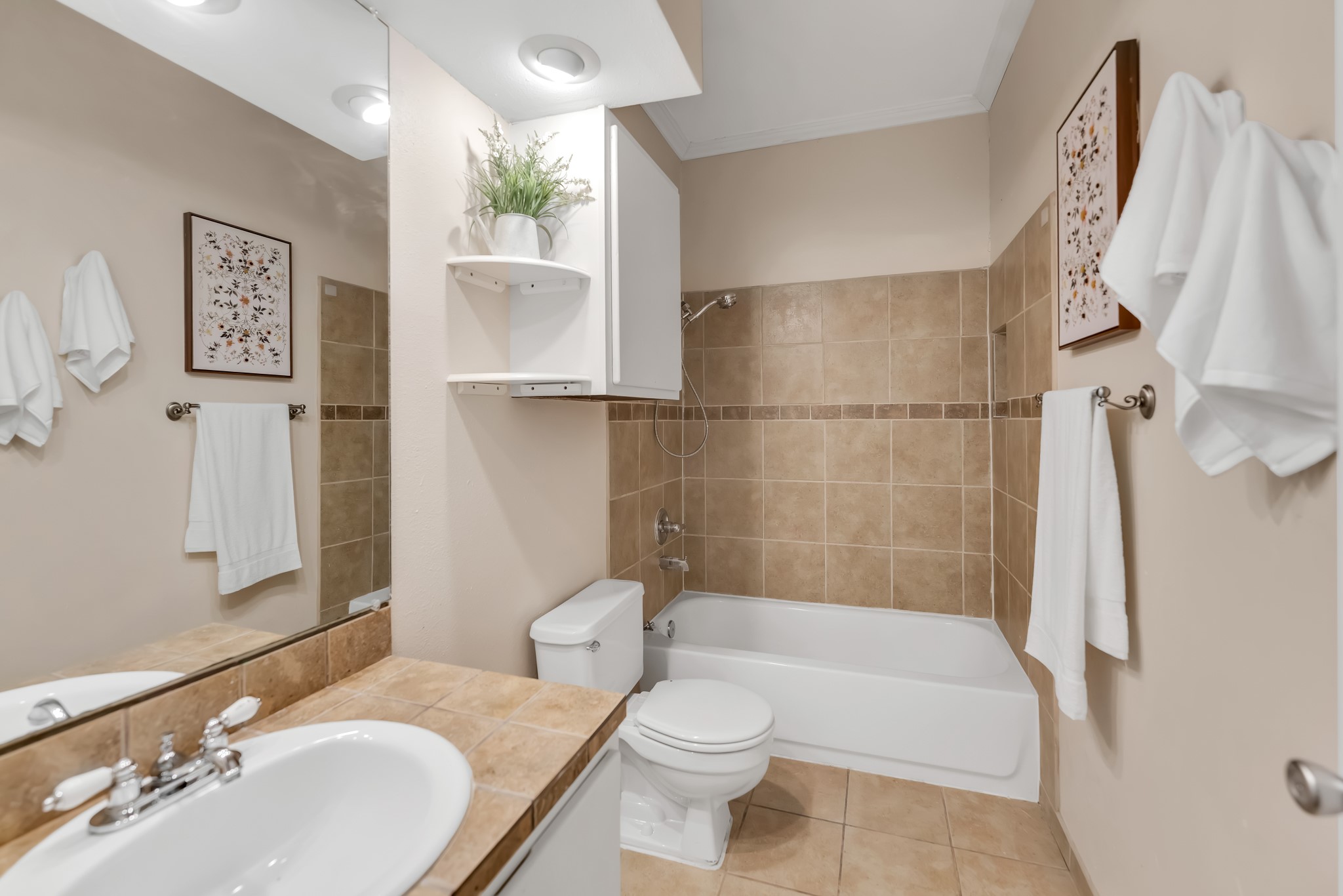 11970 Jollyville Road, Unit 104 Austin, TX 78759 - Photo 14 of 22 Bathroom featuring tiled flooring, a built-in bathtub with tiled surround, a vanity with a tiled countertop, and a recessed ceiling light