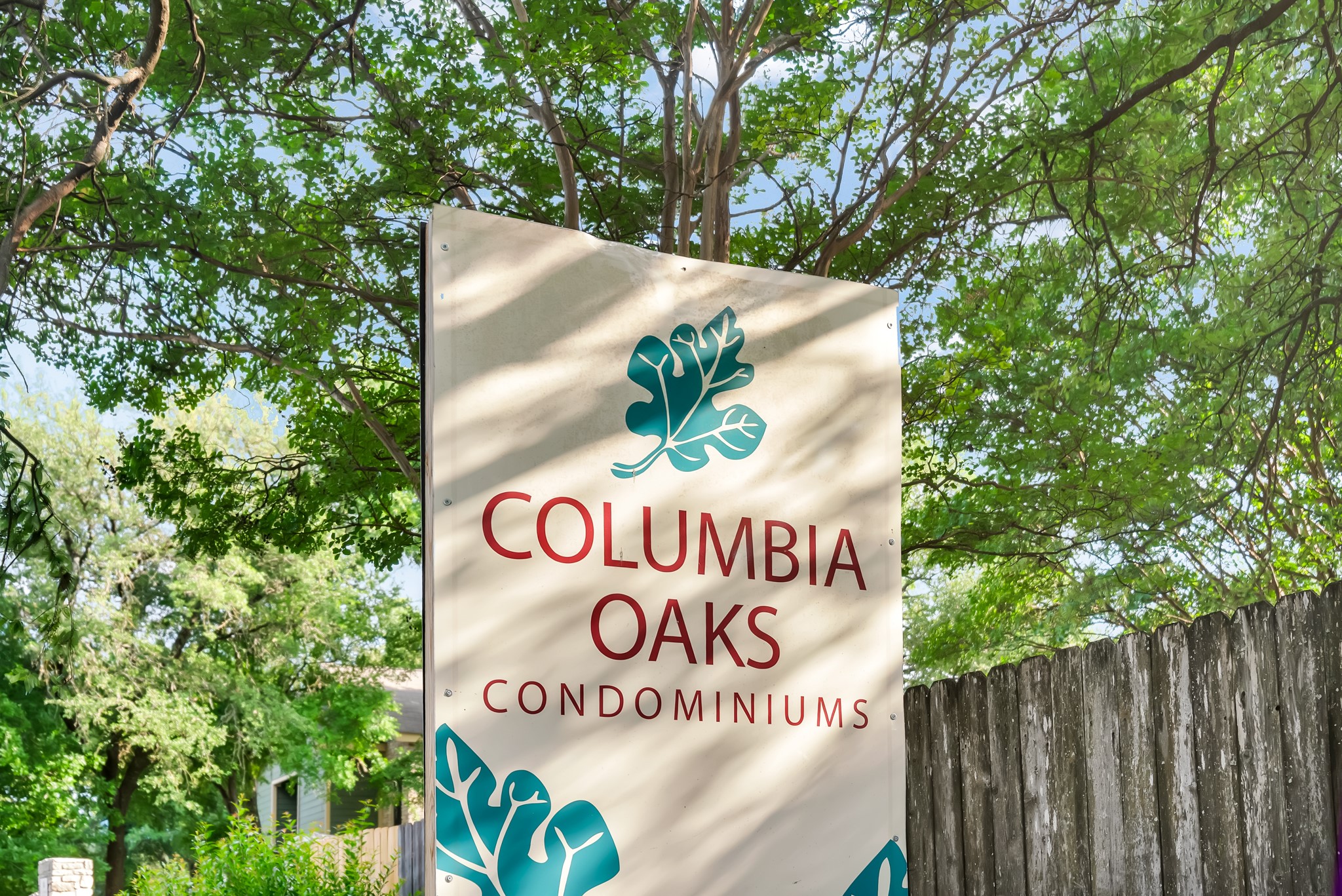 11970 Jollyville Road, Unit 104 Austin, TX 78759 - Photo 20 of 22 Signage for Columbia Oaks Condominiums, featuring a tree design