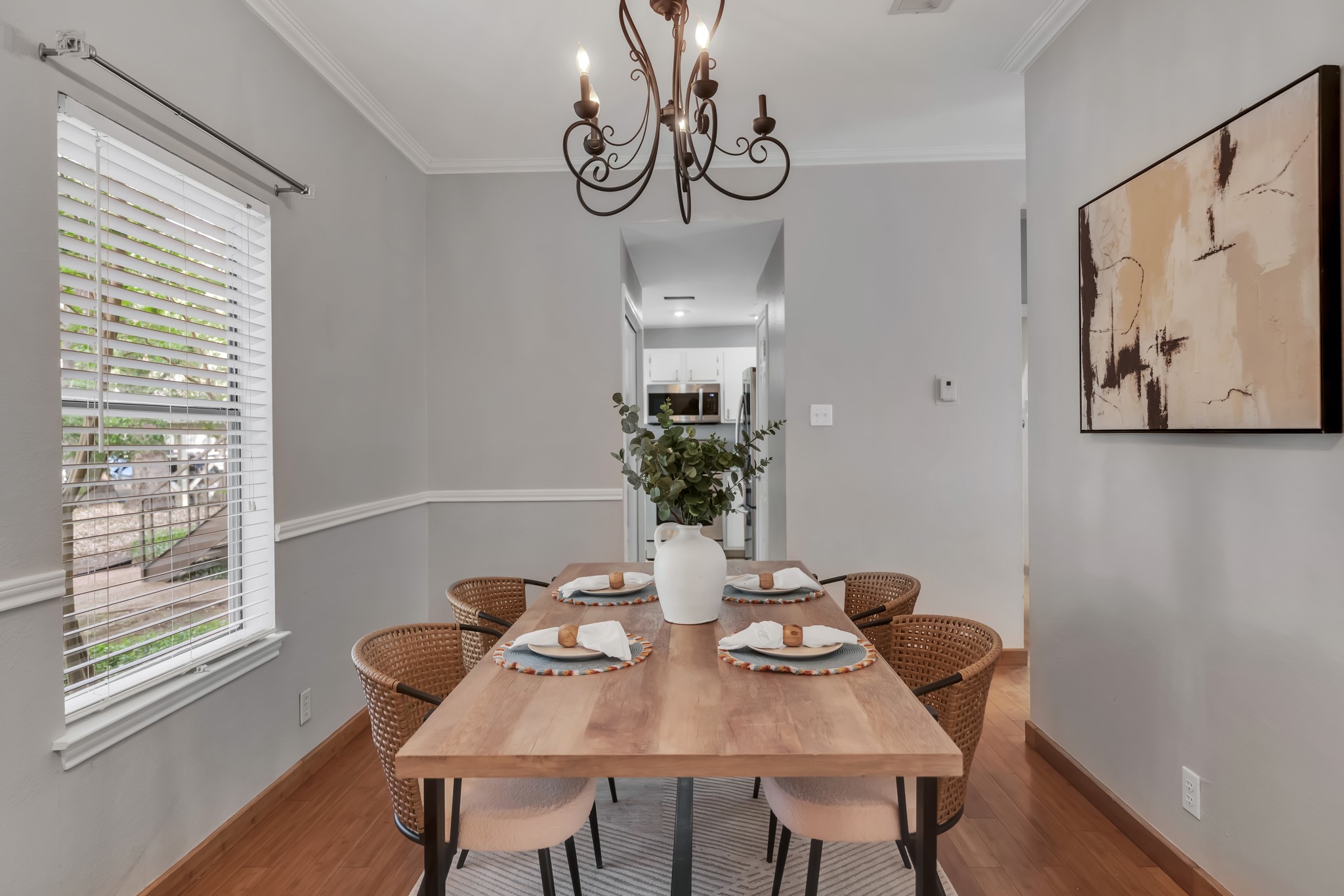11970 Jollyville Road, Unit 104 Austin, TX 78759 - Photo 3 of 22 Dining area featuring wood flooring, a decorative light fixture, and a window with blinds