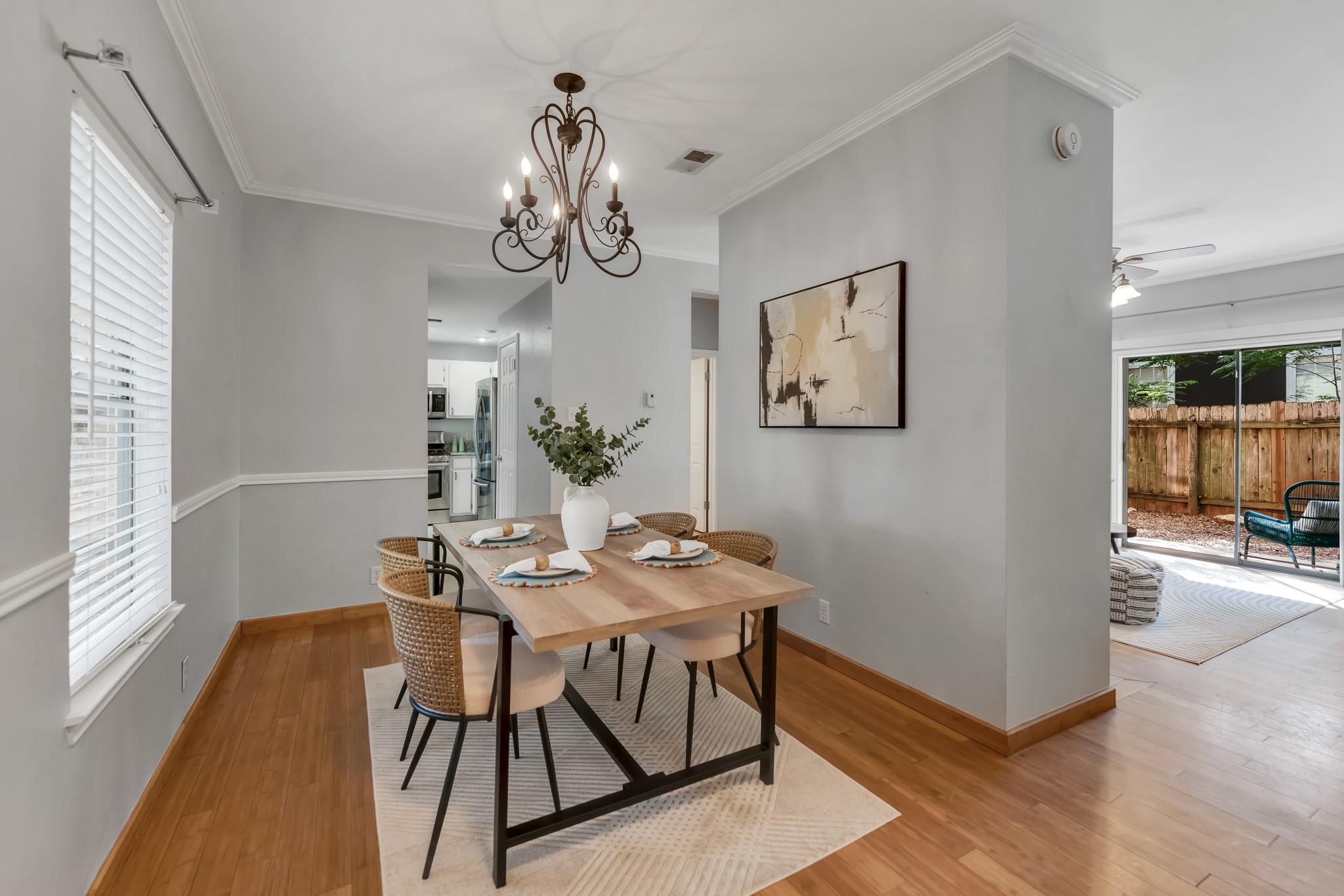 11970 Jollyville Road, Unit 104 Austin, TX 78759 - Photo 4 of 22 Dining area featuring light hardwood flooring, crown molding, and a decorative chandelier