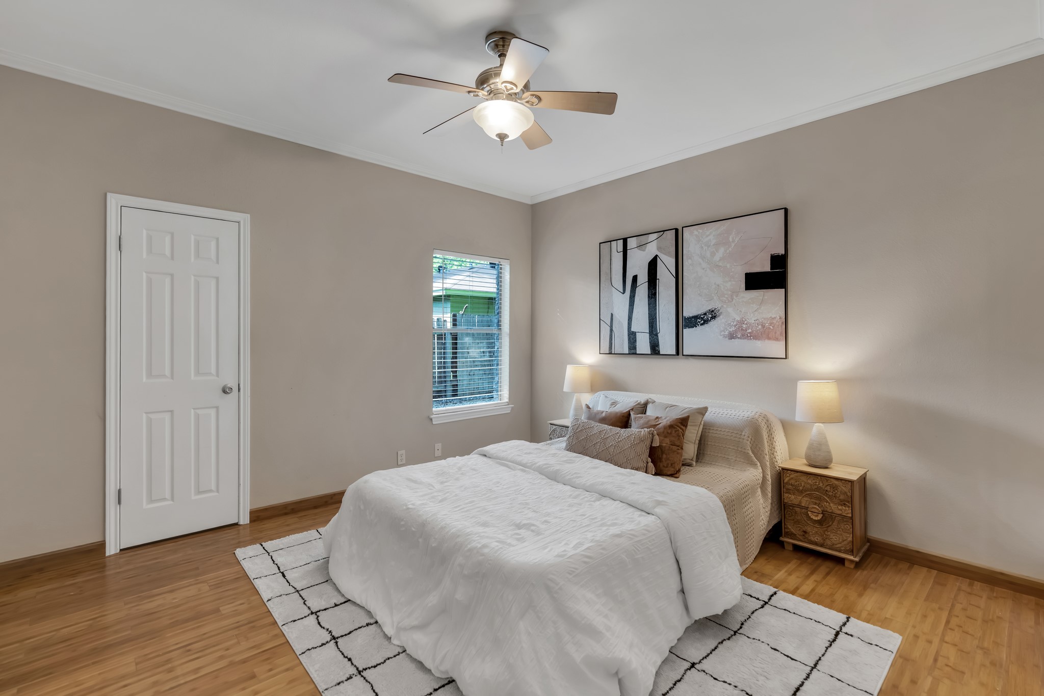 11970 Jollyville Road, Unit 104 Austin, TX 78759 - Photo 10 of 22 The bedroom features wood flooring, a ceiling fan, a window with blinds, and white trim