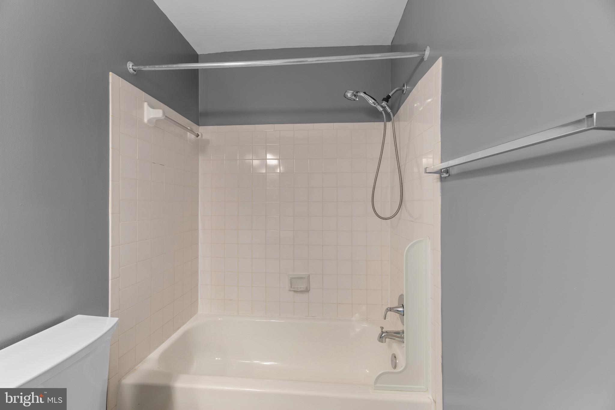 9302 Player Drive, Unit 155 Laurel, MD 20708 - Photo 38 of 43 a bathroom with a glass shower door