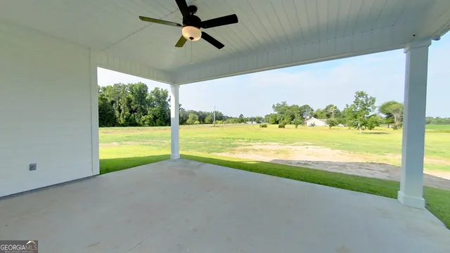 a view of an empty room with a floor to ceiling window and an outdoor view