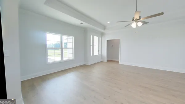 a kitchen with stainless steel appliances granite countertop a sink dishwasher a stove and a microwave oven with white cabinets