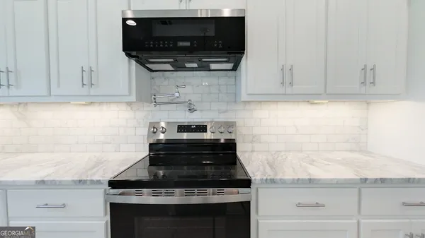a view of a kitchen sink and natural light