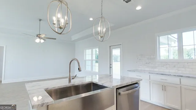 a kitchen with granite countertop white cabinets and a granite counter tops