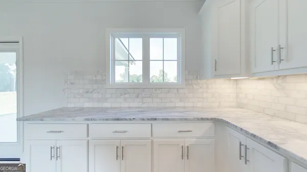 a kitchen with granite countertop a sink stainless steel appliances and cabinets