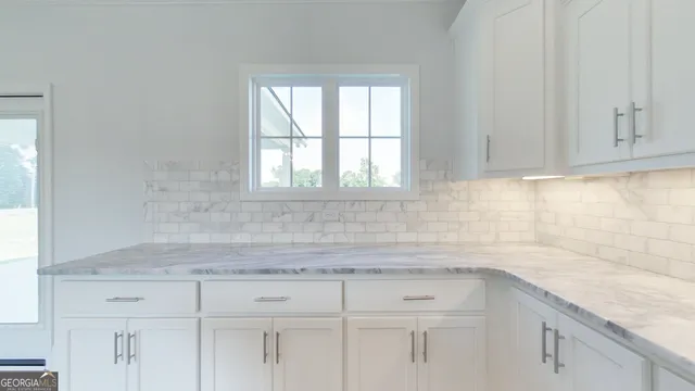 a kitchen with granite countertop a sink stainless steel appliances and cabinets
