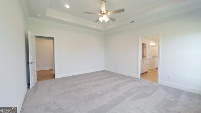an empty room with a ceiling fan and a window