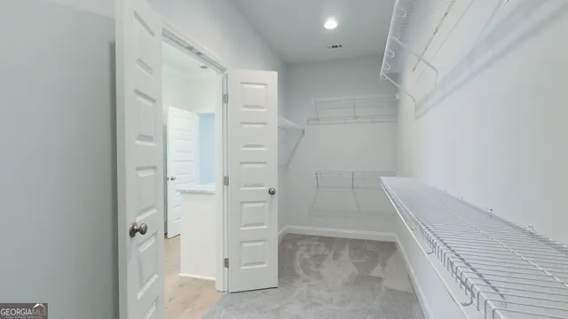 a bathroom with a granite countertop sink and white cabinets