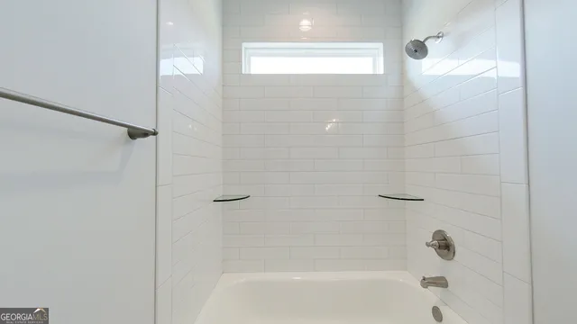 an empty room with a chandelier fan and windows
