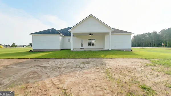 a view of a house with a yard and garage