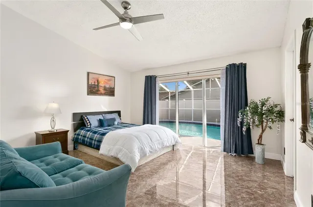 a bedroom with furniture and a large window