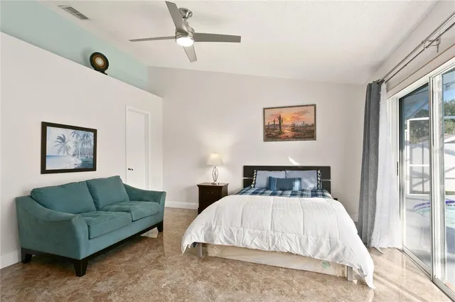 a bedroom with a bed couch and window