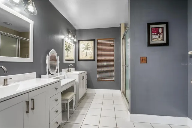 a spacious bathroom with a mirror sink and shower