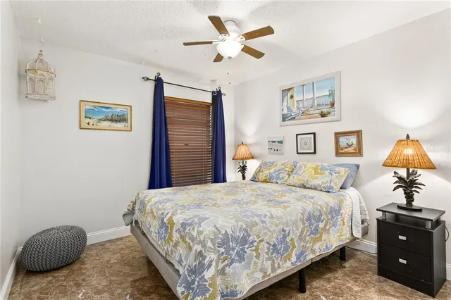 a bedroom with a bed and lamp