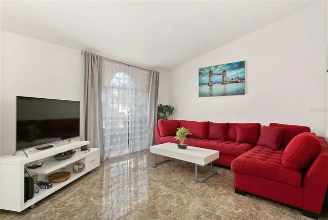 a living room with furniture and a flat screen tv
