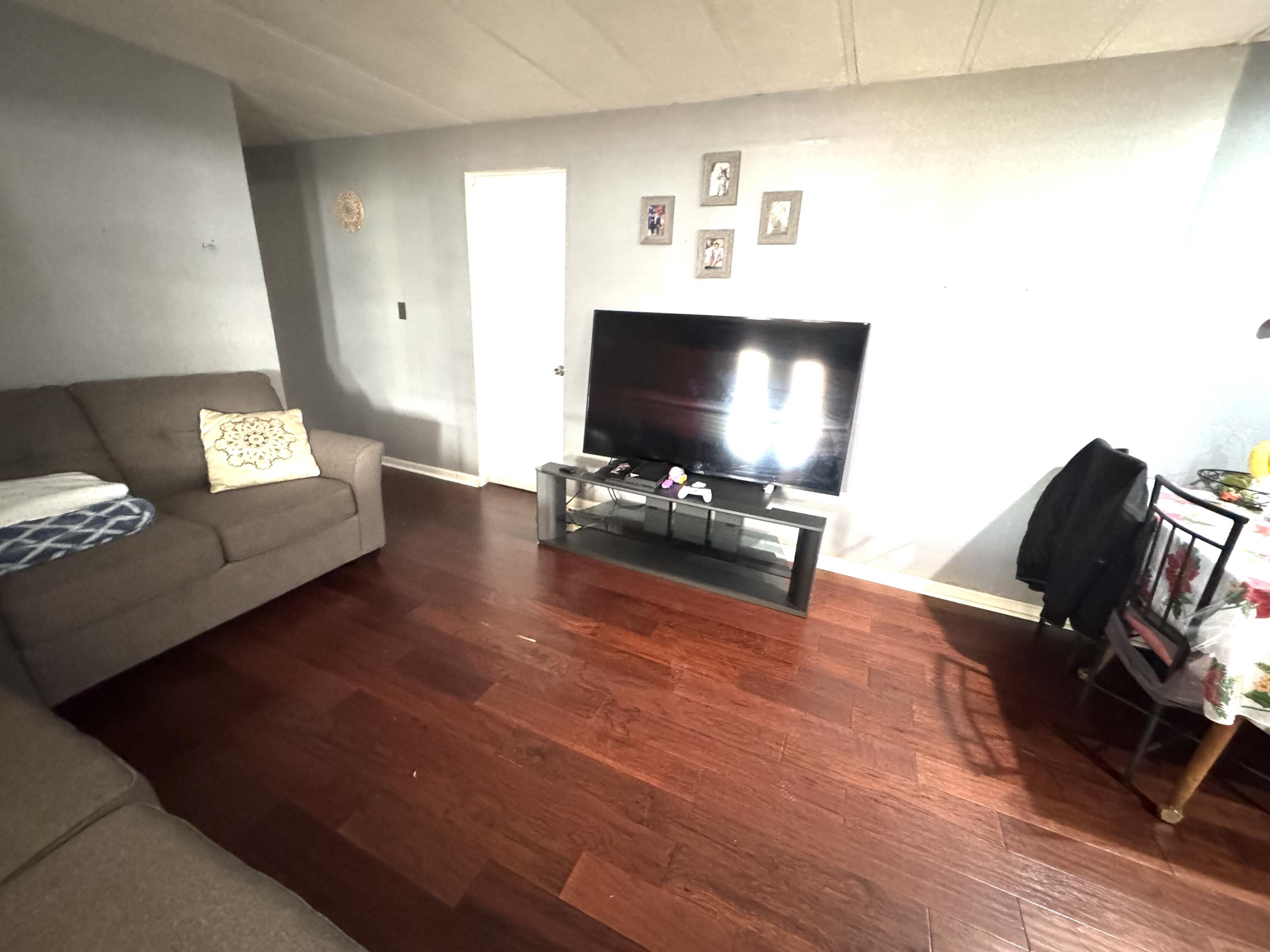 45800 Challanger Way Lancaster, CA 93535 - Photo 12 of 16 a living room with furniture and a flat screen tv