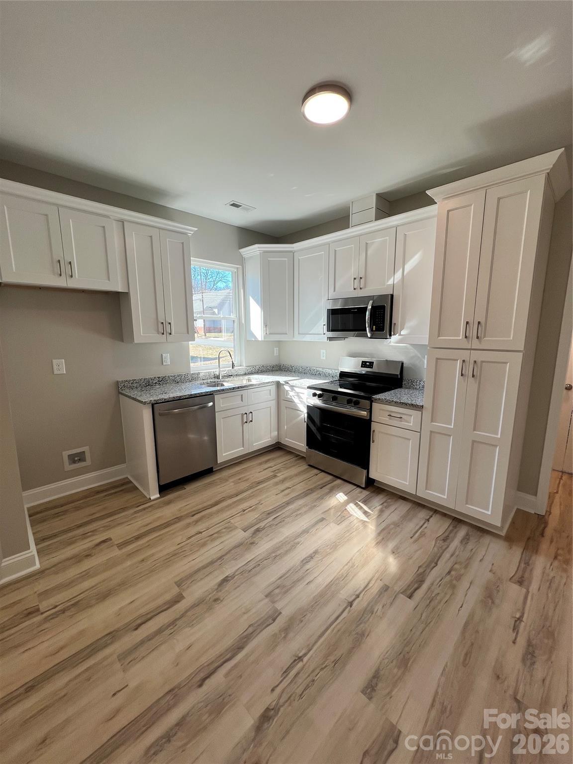 722 Austin Street Albemarle, NC 28001 - Photo 11 of 22 a kitchen with granite countertop a refrigerator stove top oven and sink