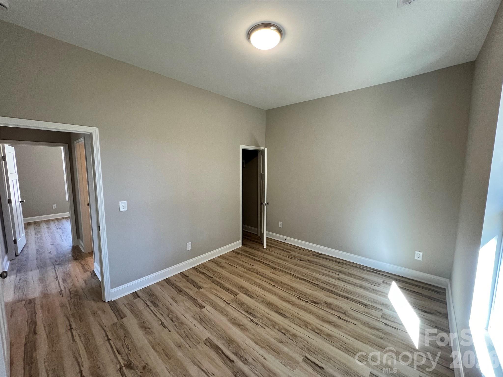 722 Austin Street Albemarle, NC 28001 - Photo 19 of 22 wooden floor in an empty room with a window