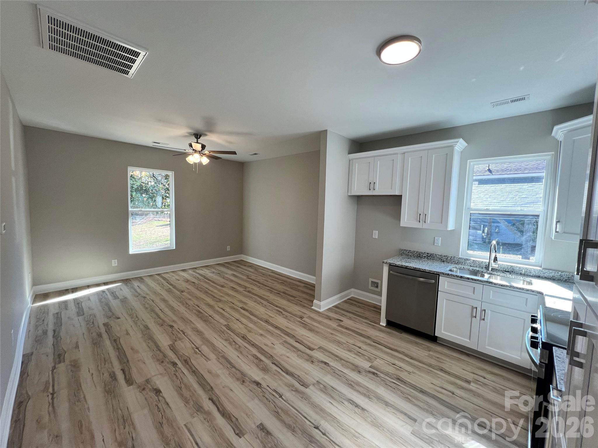 722 Austin Street Albemarle, NC 28001 - Photo 7 of 22 a kitchen with granite countertop a stove cabinets and wooden floor