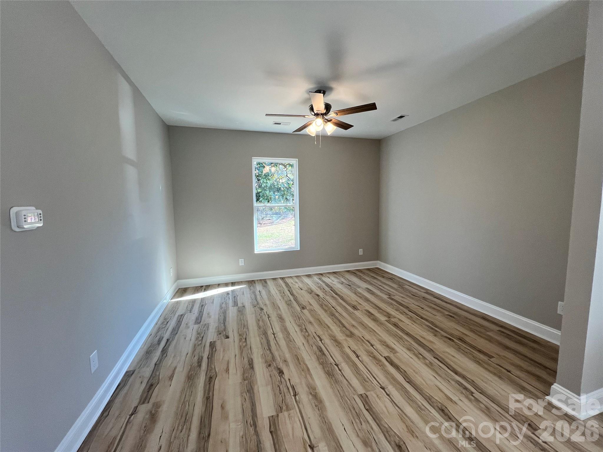 722 Austin Street Albemarle, NC 28001 - Photo 8 of 22 wooden floor in an empty room with a window