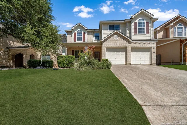 a front view of a house with a yard and garage