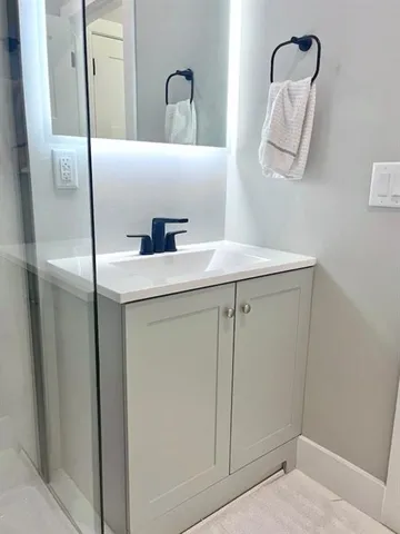 a bathroom with a sink and a mirror