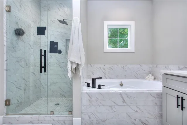 a bathroom with a bathtub and a shower