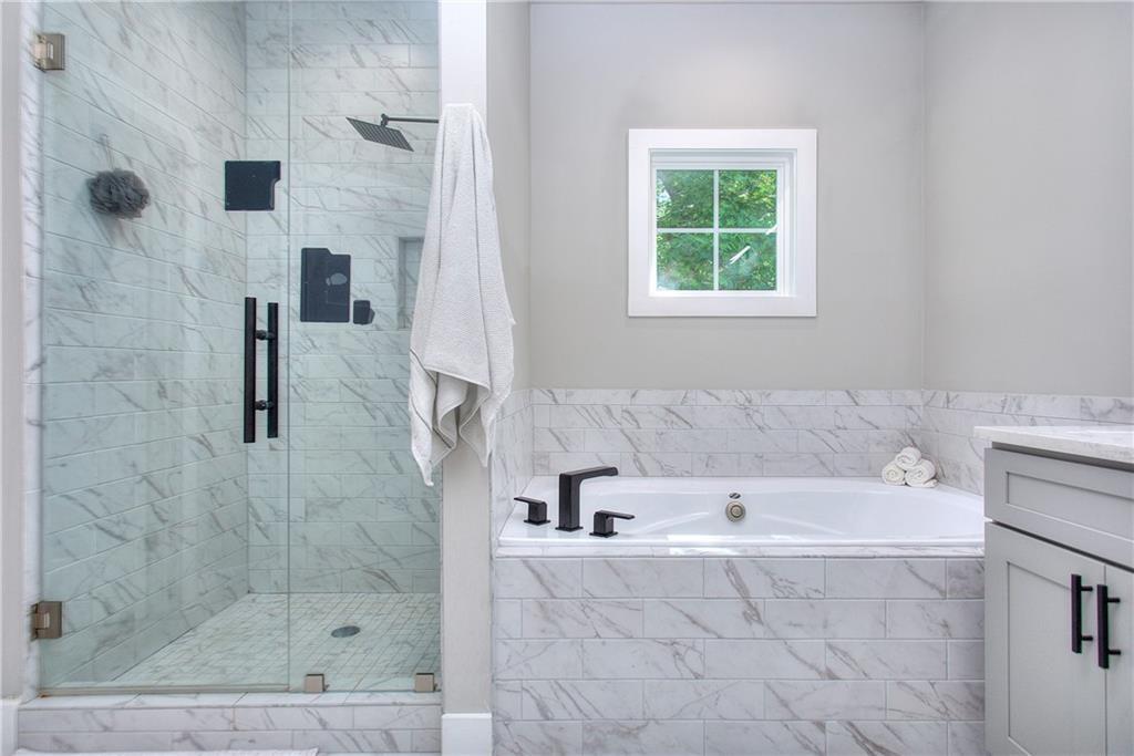 419 Mc Innes Circle Marietta, GA 30060 - Photo 18 of 33 a bathroom with a bathtub and a shower