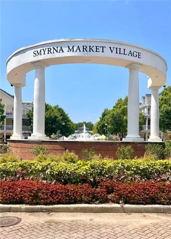 a street sign on a sidewalk next to a building