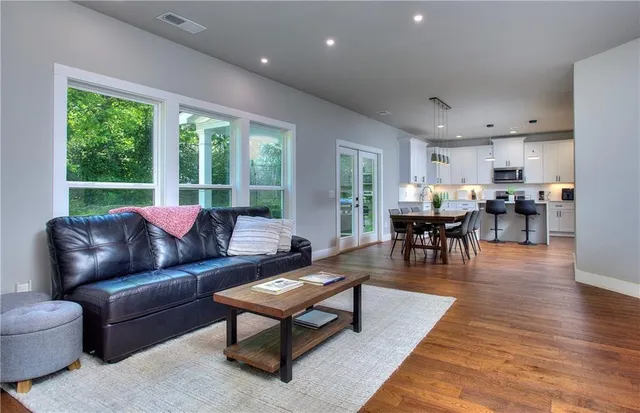 a living room with furniture and wooden floor