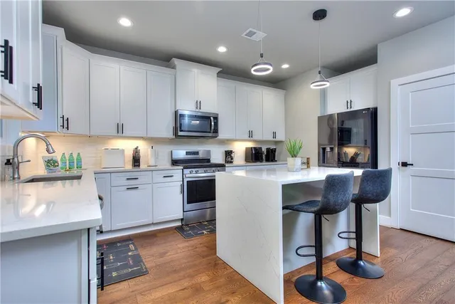 a kitchen with a sink cabinets and window