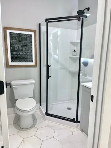 a bathroom with a toilet and a shower