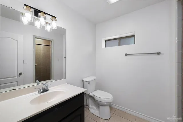 a bathroom with a sink a toilet and mirror