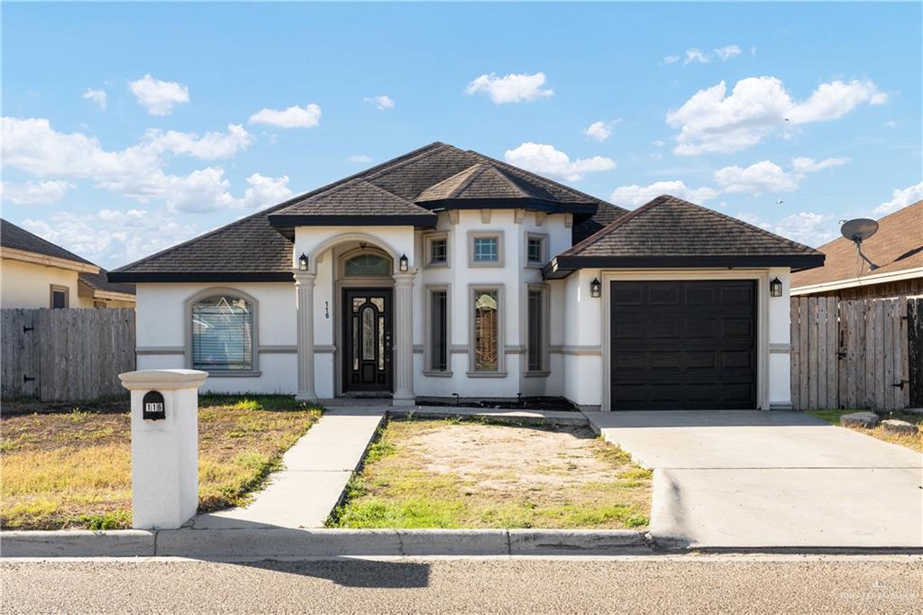 116 Santa Elena Lane Rio Grande City, TX 78582 - Photo 2 of 16 a front view of a house with garden