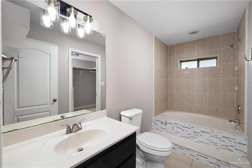 116 Santa Elena Lane Rio Grande City, TX 78582 - Photo 9 of 16 a bathroom with a sink a toilet and shower