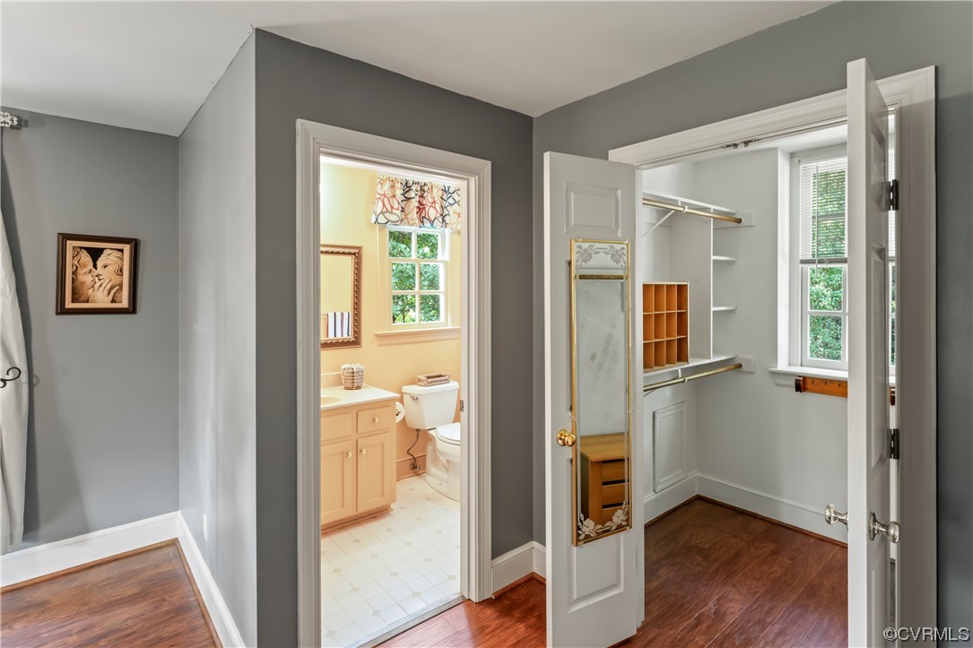 9737 Cole Mill Road Richmond, VA 23237 - Photo 14 of 50 a view of a hallway with wooden floor and a bedroom